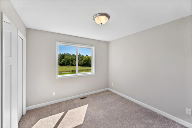 unfurnished bedroom with light colored carpet