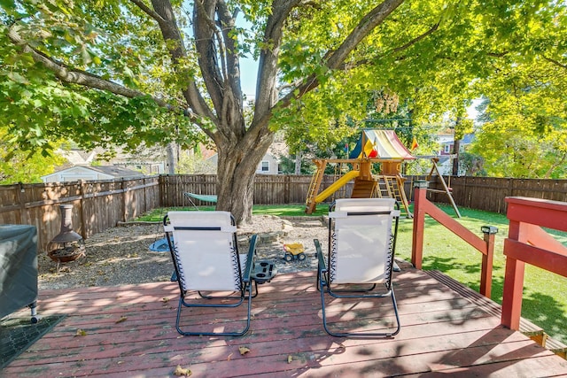 wooden deck featuring a playground