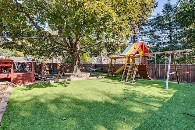 view of yard featuring a playground and a wooden deck