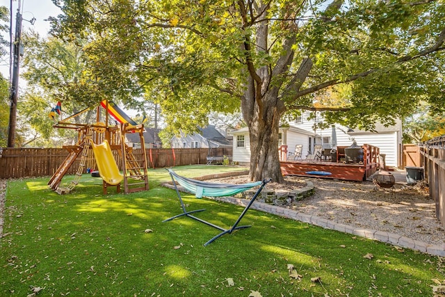 view of yard featuring a playground and a wooden deck