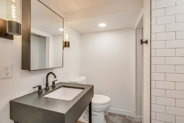 bathroom featuring tile patterned floors, vanity, and toilet