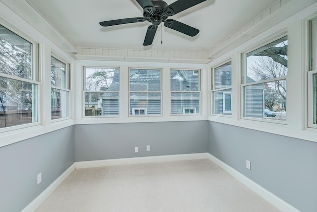 unfurnished sunroom featuring ceiling fan