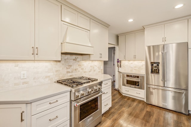 kitchen featuring decorative backsplash, custom range hood, dark hardwood / wood-style floors, and high quality appliances