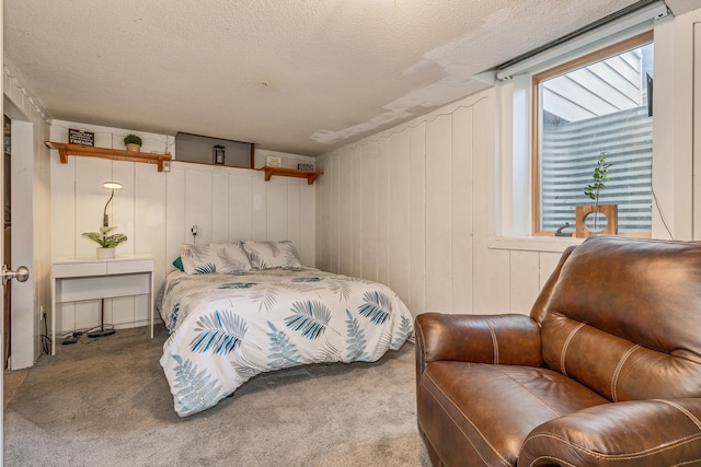 bedroom with wood walls, carpet floors, and a textured ceiling