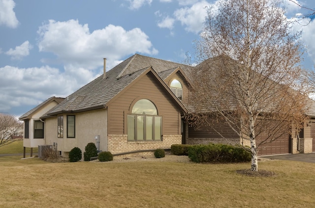 view of side of home with cooling unit and a lawn