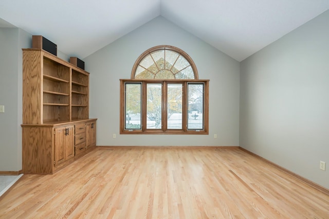 unfurnished living room featuring light hardwood / wood-style flooring and lofted ceiling