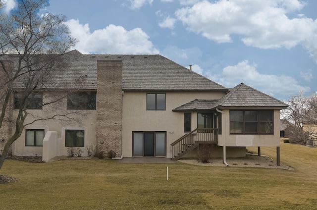 rear view of house featuring a yard