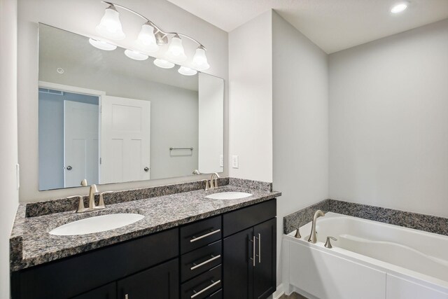 bathroom with vanity and a bathtub