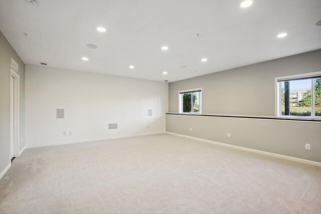 carpeted empty room featuring plenty of natural light