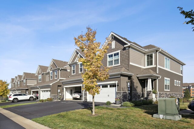 view of front of house featuring a front lawn and a garage