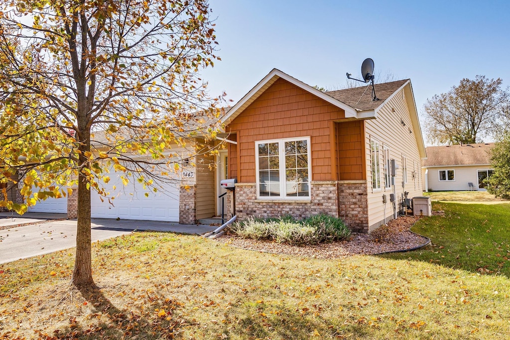 view of front of property with a front yard and a garage