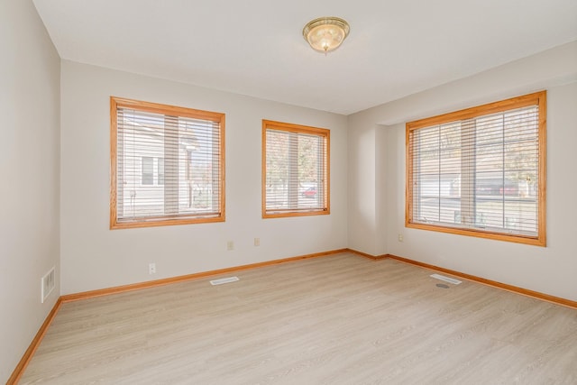 spare room featuring light hardwood / wood-style flooring