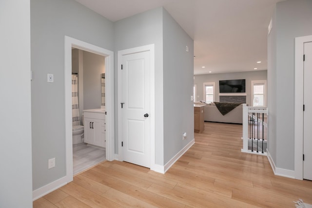 corridor with light hardwood / wood-style floors