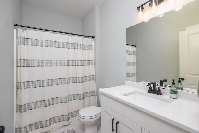 bathroom with vanity, toilet, and walk in shower