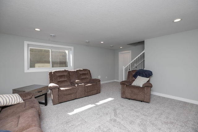 carpeted living room with a textured ceiling