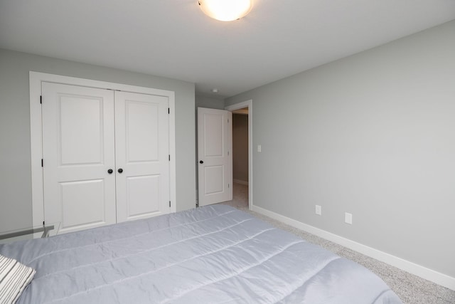 unfurnished bedroom with light carpet and a closet