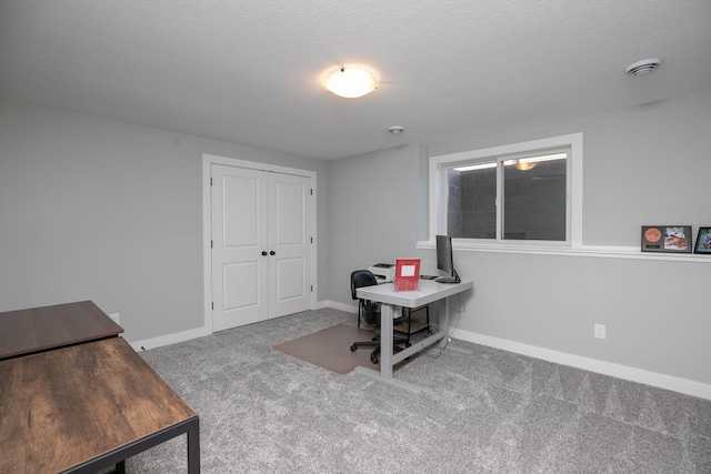 office area featuring carpet flooring and a textured ceiling