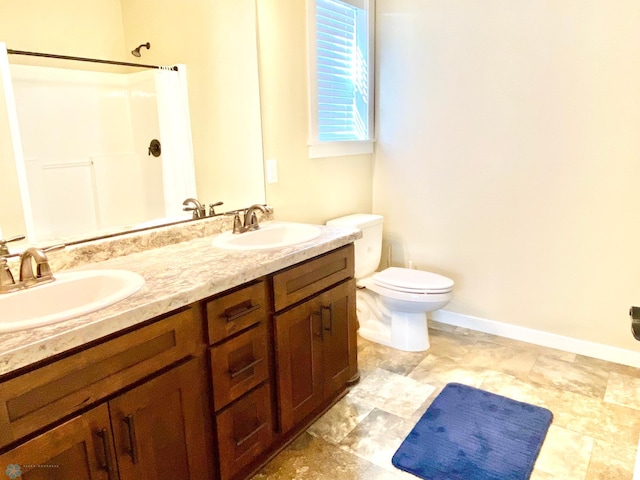 bathroom featuring vanity, toilet, and walk in shower