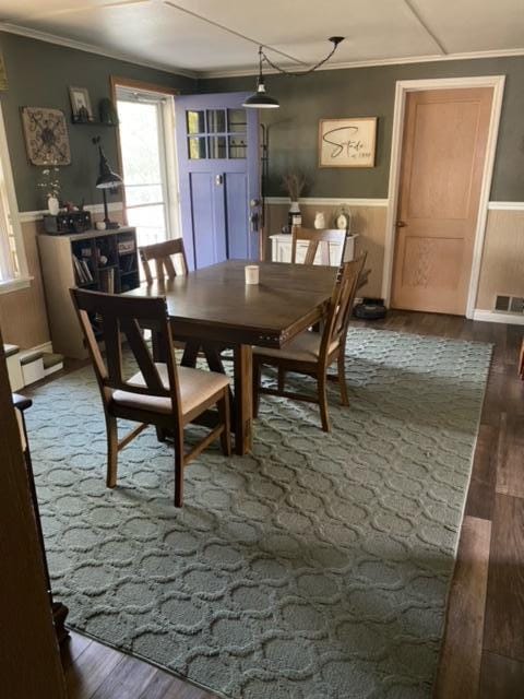 dining area with dark hardwood / wood-style floors and ornamental molding