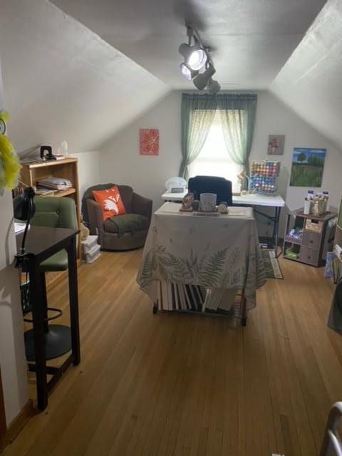 bedroom featuring wood-type flooring and vaulted ceiling