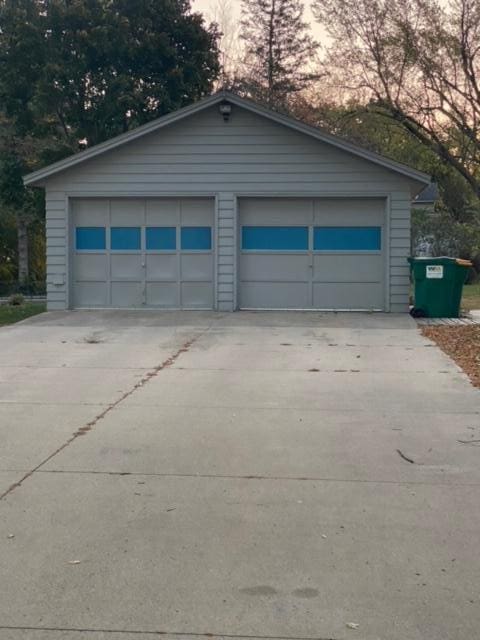 view of garage at dusk