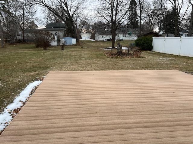 wooden terrace with a lawn