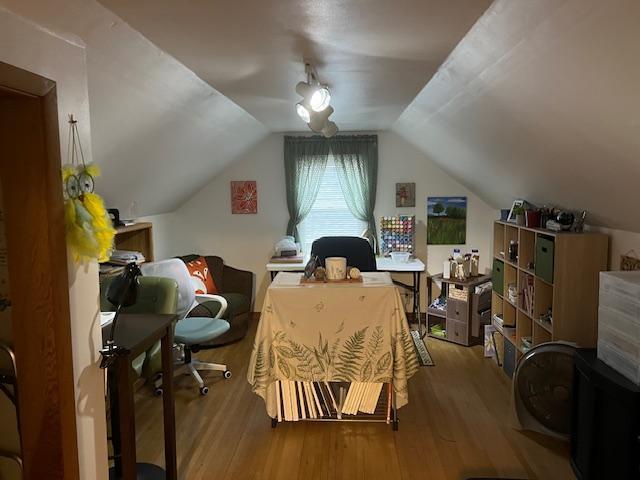 additional living space with wood-type flooring and lofted ceiling