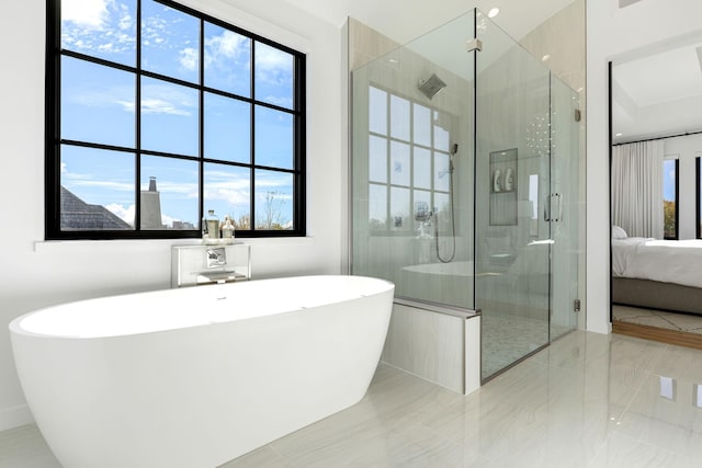 bathroom featuring shower with separate bathtub