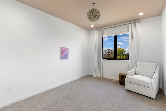 sitting room featuring light colored carpet