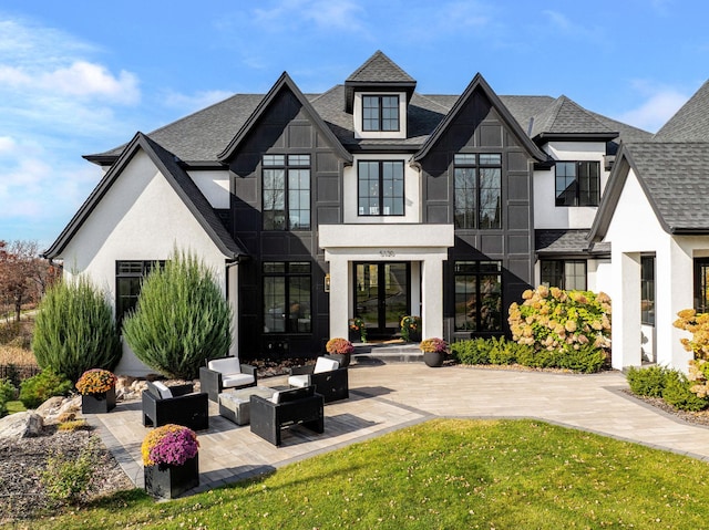 back of property with an outdoor hangout area, french doors, and a yard