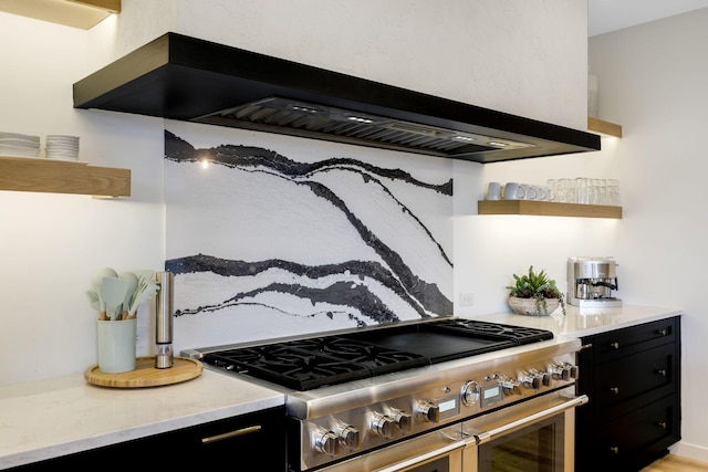 kitchen featuring stainless steel range and wall chimney range hood