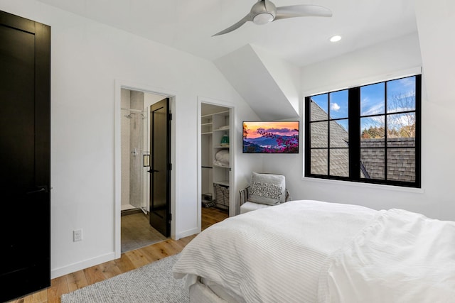 bedroom featuring a spacious closet, hardwood / wood-style flooring, ceiling fan, ensuite bath, and a closet