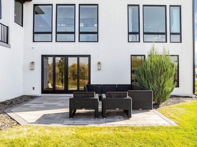 back of property with a patio area and an outdoor living space