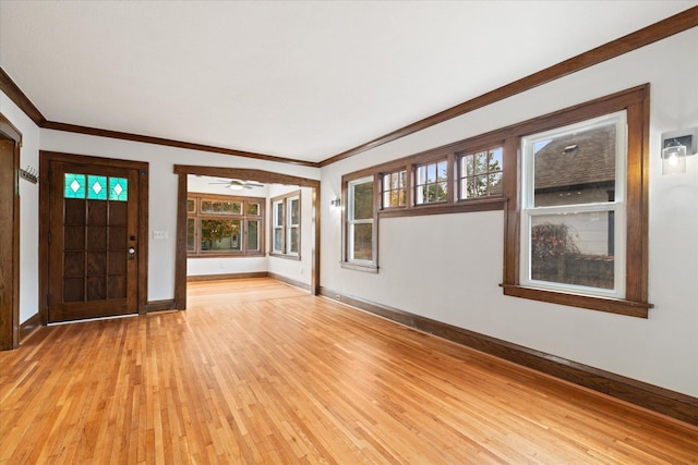 entryway featuring crown molding, light wood-type flooring, and ceiling fan