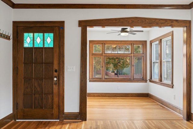 foyer with light hardwood / wood-style floors and ceiling fan