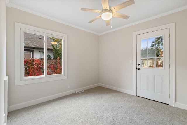 unfurnished room featuring crown molding, carpet, and ceiling fan