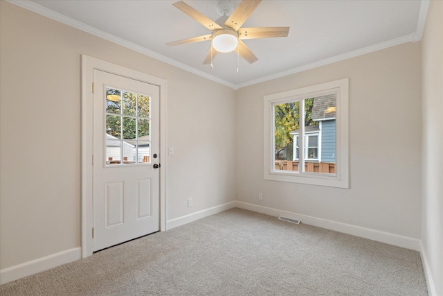 spare room featuring ornamental molding and carpet floors