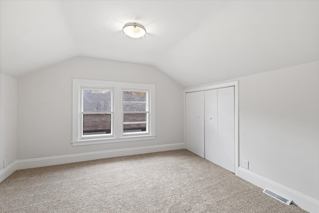 bonus room featuring carpet floors and vaulted ceiling