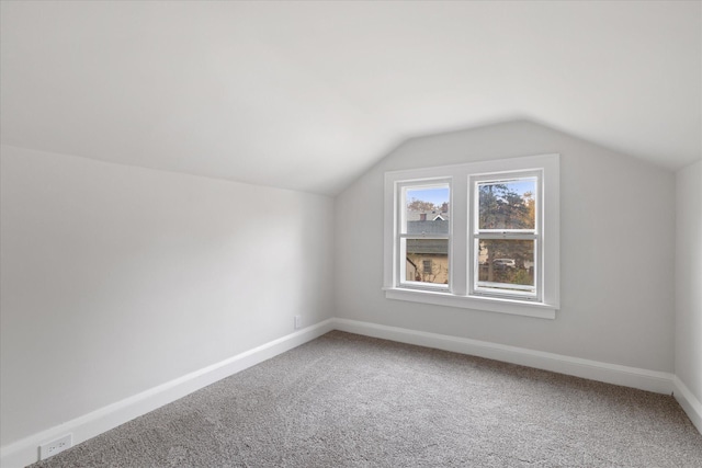 bonus room with lofted ceiling and carpet floors