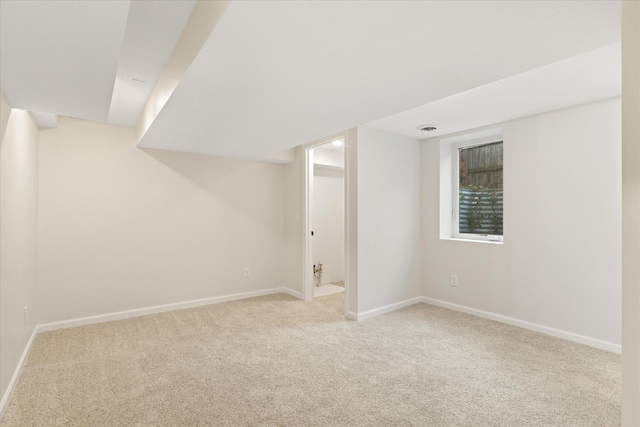 basement featuring light carpet