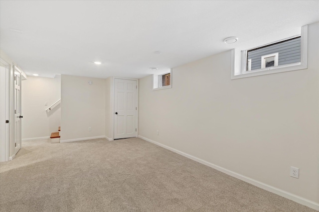 basement featuring light colored carpet