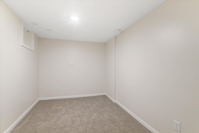 spare room featuring light colored carpet