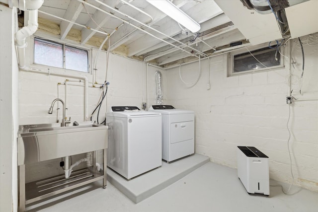 washroom featuring independent washer and dryer and sink