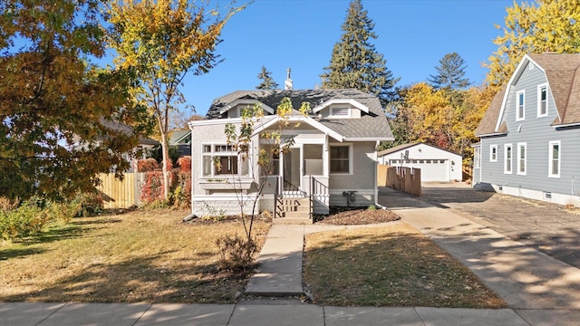 view of front of property featuring a garage and an outbuilding