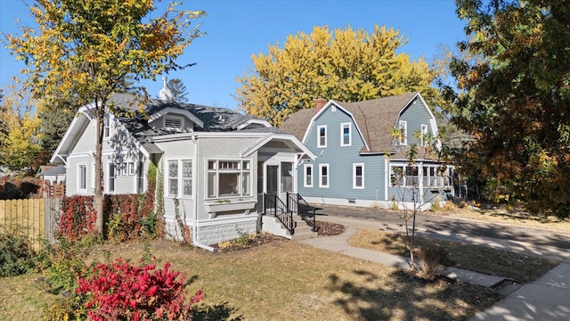 view of front of property featuring a front yard and a sunroom