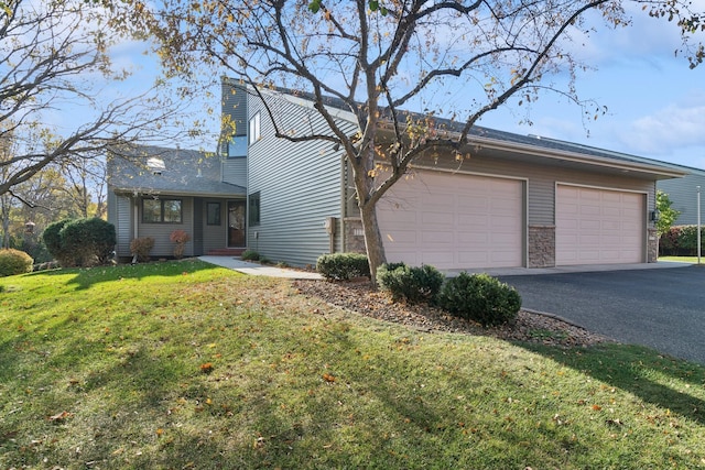 single story home with a front yard and a garage