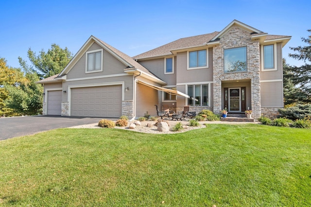 craftsman inspired home with a front yard and a garage