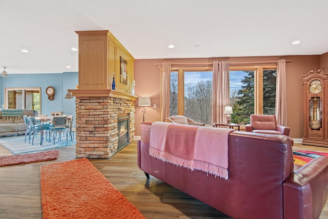 living room with light wood-type flooring and a fireplace