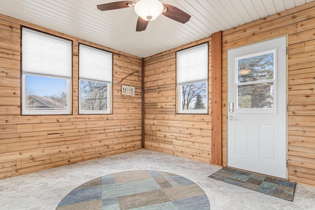 interior space with ceiling fan