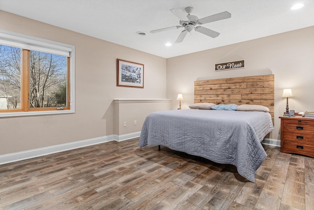 bedroom with ceiling fan and dark hardwood / wood-style flooring